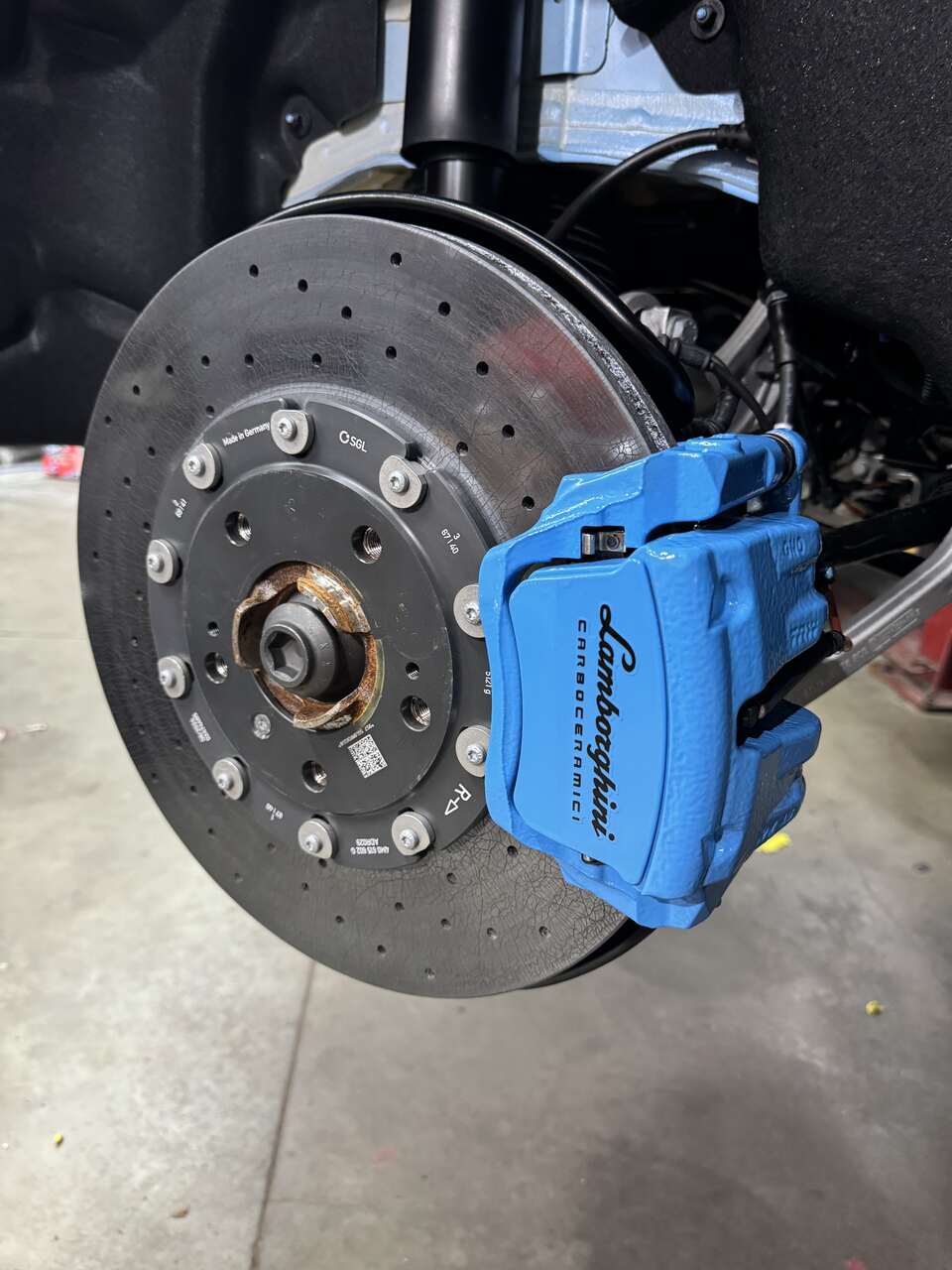 a blue and black tire brake serviced by Brake Pros of Waltham in Framingham specializing in brake caliper painting.